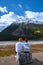 couple mid age men and woman hiking in the Canadian Rockies near Alberta Banff national park with snowy mountains