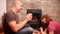 Couple, middle-aged man and woman dancing by the burning fireplace, smiling, concept of love, family relationships, good mood