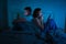 Couple on mobile phone late at night in social network addiction and relationship domestic problems