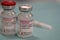 A couple of Moderna Covid-19 Vaccine vials with sterile syringe