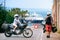 A couple of motorcycle riders. Love and relationships. Tourism and travel. Motorcycle for tours around the world. Street of sunny