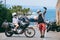 A couple of motorcycle riders taking pictures on the phone, taking selfies. Tourism and travel. Motorcycle for tours around the