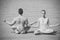 Couple of muscular man and woman meditating, yoga pose, love