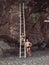 Couple near large rock on a ladder