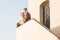 Couple of newlyweds standing on the stairs in their new home.