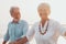 Couple of old mature people walking on the sand together and having fun on the sand of the beach enjoying and living the moment.