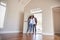 Couple Opening Door And Walking In Empty Lounge Of New Home