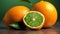 a couple of oranges sitting on top of a wooden table next to a green leafy piece of fruit on top of a table