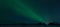 Couple outstretches arms and celebrates seeing the spectacular aurora borealis.