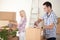 Couple packing moving boxes