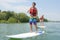 Couple paddle boarding on lake