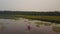 Couple paddling in kayaks enjoying a calm, misty lake.