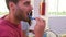 Couple In Pajamas Brushing Teeth In Bathroom