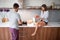 Couple in pajamas prepare breakfast together