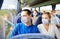 Couple or passengers in masks in travel bus