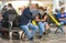 A couple of passengers wearing coronavirus protection masks share hand sanitizer before flight departure in Pisa Airport, Italy