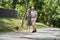 Couple of pensioner enjoying summer walking while going through the park