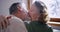 a couple of pensioners, an elderly husband removes the protective mask from his wife and kisses on the lips. end of the