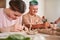 Couple of people with special needs doing carefully dishes from the clay