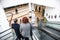 Couple of people traveling down an escalator inside a modern clean building