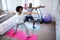 Couple performing exercise in bedroom