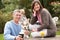 Couple With Pet Dog Outdoors Enjoying Drink In Pub