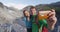Couple phone selfie New Zealand tourists smiling happy by Franz Josef Glacier