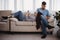 Couple with phones in living room