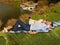 Couple, picnic and lying by lake with wine outdoor, having fun and bonding on vacation. Portrait, alcohol and man and