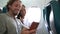 Couple in plane on travel taking selfie photo or video going