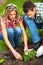 Couple planting flowers