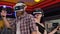 A couple play video games using a virtual reality headset with glasses.