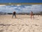 Couple is playing beachvolleyball