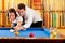 Couple playing billiard expertise teacher