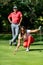 Couple playing golf, young woman reading green, getting ready to putt