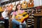Couple playing guitars in music shop