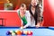 Couple playing pool billiard game