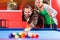 Couple playing pool billiard game