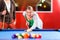 Couple playing pool billiard game