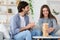 Couple playing wooden blocks at living room at home