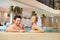 Couple in the pool resting spa center.