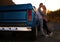 Couple, portrait and sunset by pickup truck for road trip with love, romance or date on adventure, travel or journey