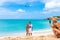 Couple pose for photo on beach with aircraft landing behind