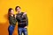 Couple posing in jeans type commercial fashion style on yellow wall