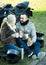 Couple posing near motor bike with sandwitches and coffee