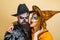 Couple posing with Pumpkin. Happy family celebrating for Halloween.