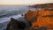 Couple in Praia de Odeceixe beach in Costa Vicentina at sunset, Portugal