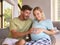 Couple With Pregnant Woman In Bedroom At Home With Man Feeling Baby Kicking