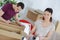 Couple preparing boxes man marking contents with pen