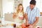 Couple Preparing Healthy Breakfast In Kitchen